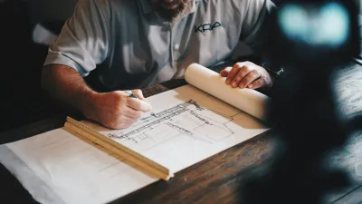 Professional reviewing an architectural floor plan